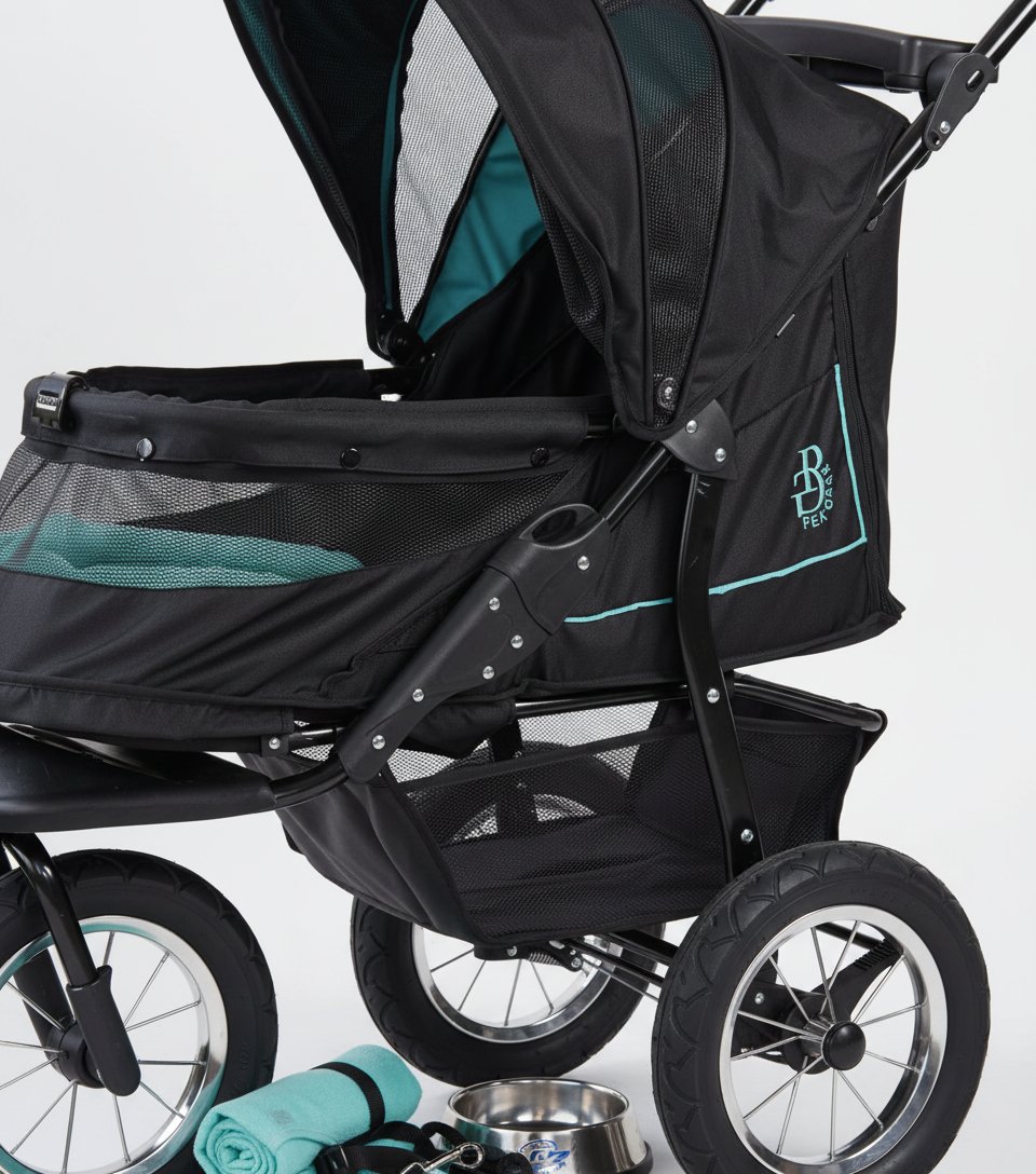 Caribbean blue pet stroller with zipperless mesh entry and gel-filled tires, showing plush pad and one-hand fold design โ view 5b